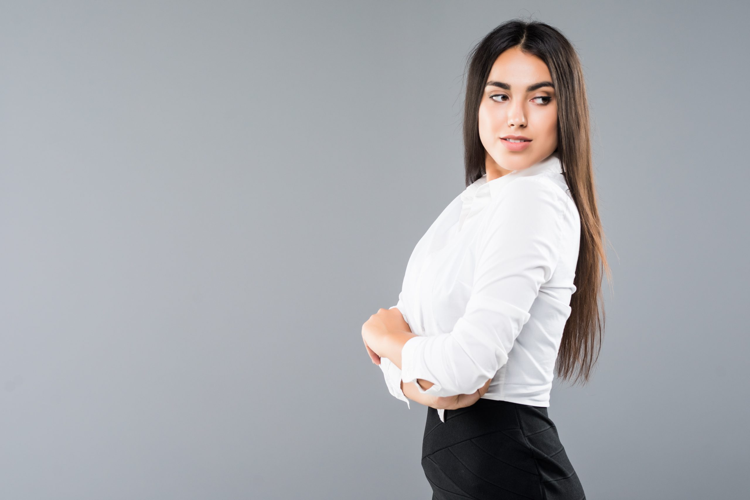 Closeup profile of confident business woman looking forward on gray background