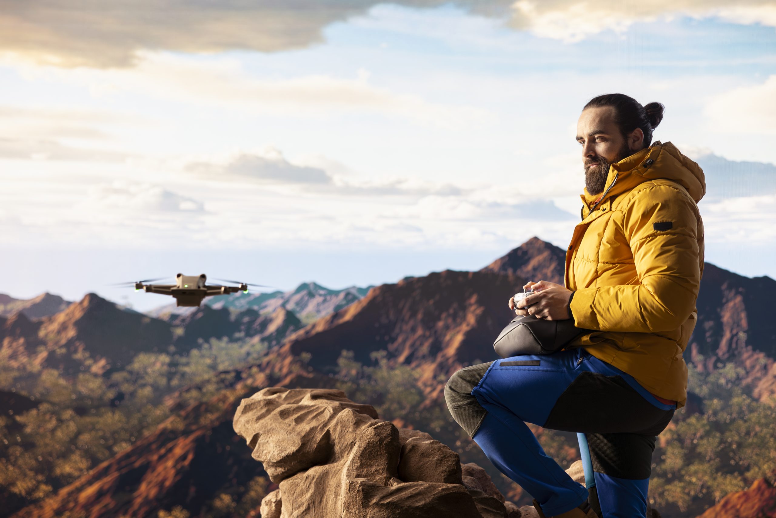 Content creator enjoying the fresh air and filming with his drone, recording professional video on mountain range valley aerial view. Influencer filming his latest travel vlog.
